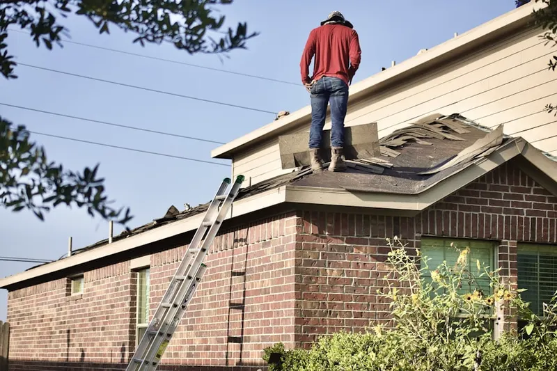 Professional roofer working on a residential roof in The Reserve at Trewellyn